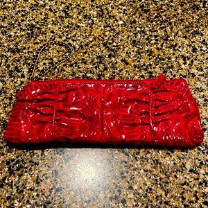 Red faux snake skin clutch with chain handle.